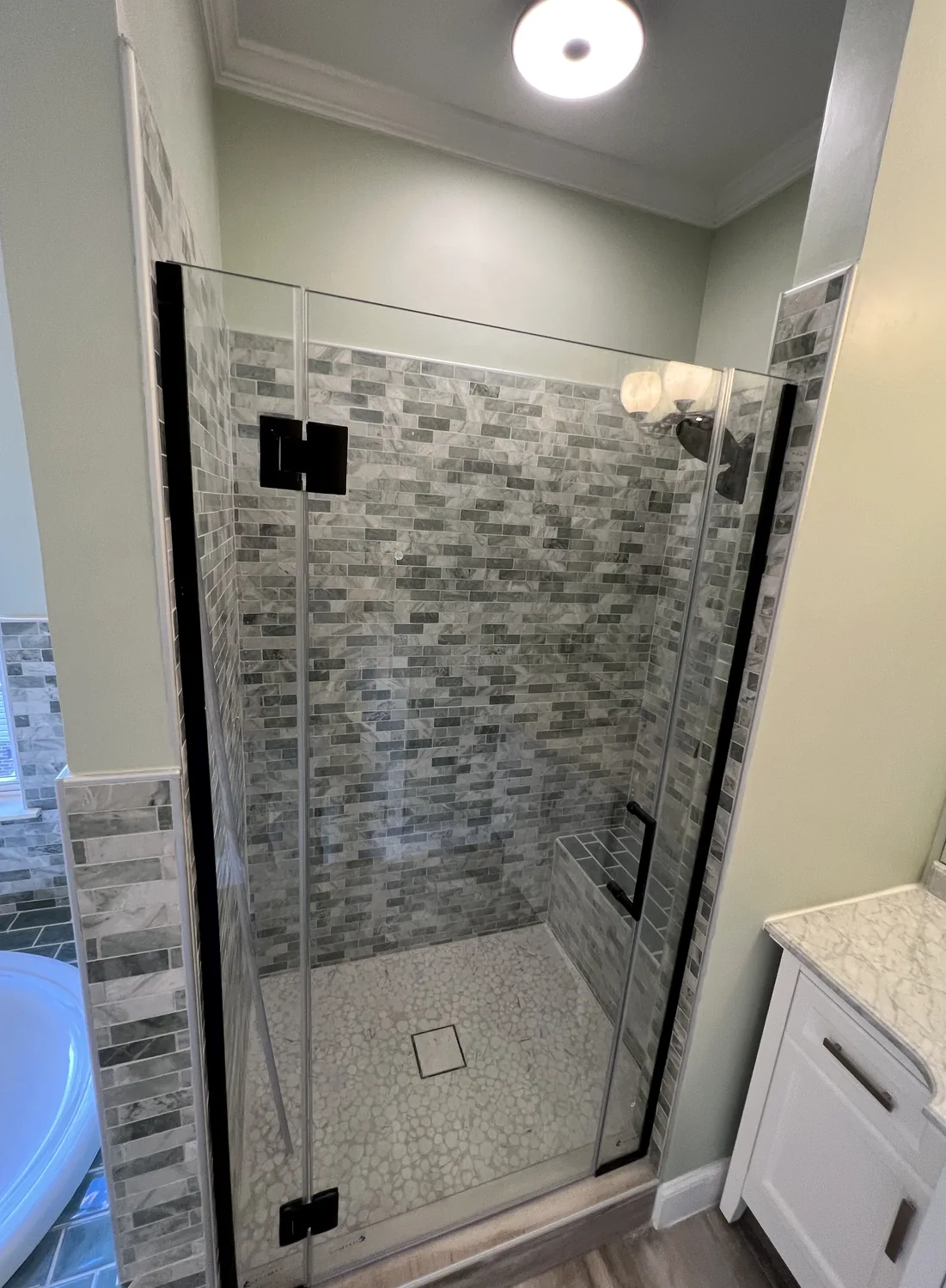 Gray tile glass shower installation in Charlotte NC with tile shower floor